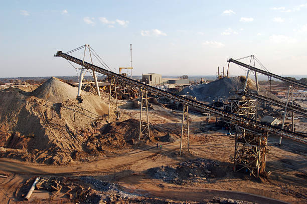 "Conveyor belts feed broken rock into two different stockpiles (oxides and sulphides) at an open-pit copper mine in Zambia, Africa."