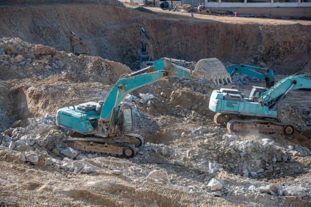 The excavator on the construction site is working The excavator on the construction site is working