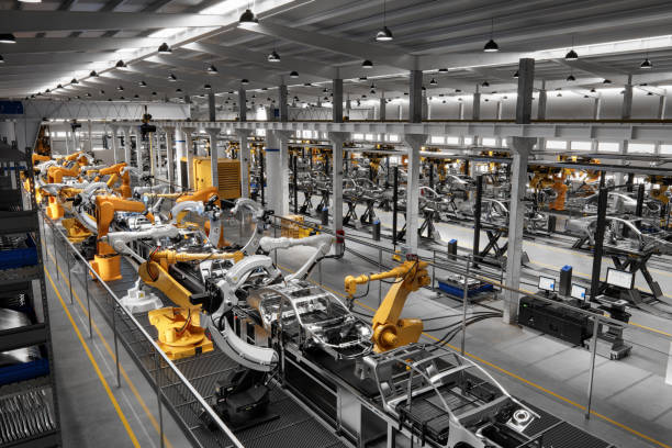 s3 High angle view of cars on production line in factory. Many robottic arms doing welding on car metal body in manufacturing plant. Image in 3D render.