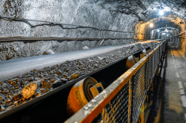 Belt conveyor in an underground tunnel. Transportation of ore to the surface. Belt conveyor in an underground tunnel. Transportation of ore to the surface.