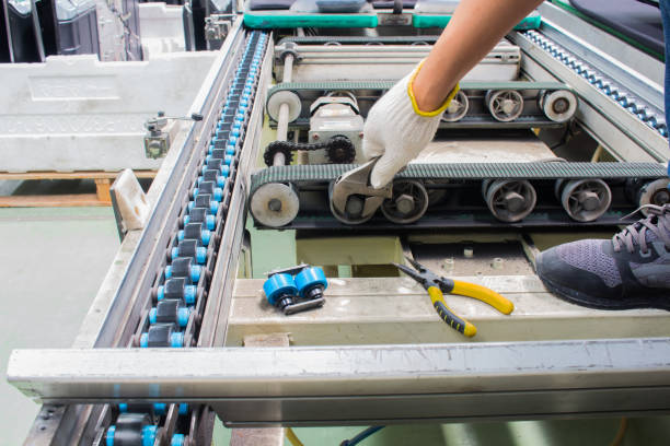 worker maintenance and repair conveyor belt in factory worker maintenance and repair conveyor belt in factory